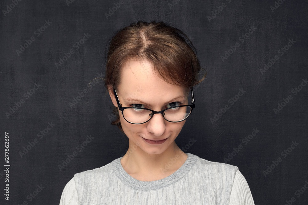 Fototapeta premium Portrait of cute and intrigued girl with eyeglasses