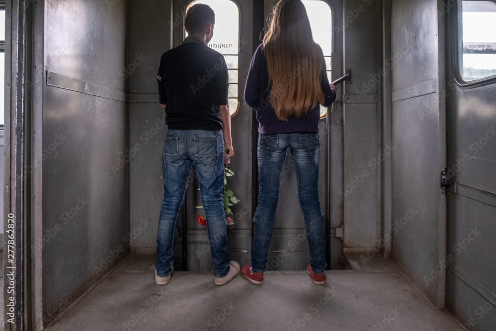 boy and girl are at the door of the train boy and girl are at the door of the train
