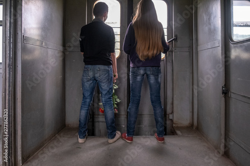 boy and girl are at the door of the train © Sergei
