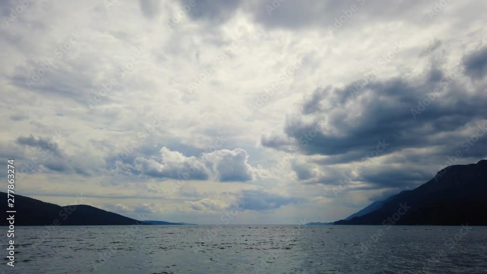 A view from the Aegean Sea showing the silhouette of Akyaka shoreline (Gulf of Gokova) on a cloudy spring afternoon. Seagulls can be seen flying across. Shot and presented at 60 fps. A view from the Aegean Sea showing the silhouette of Akyaka shoreline (Gulf of Gokova) on a cloudy spring afternoon. Seagulls can be seen flying across. Shot and presented at 60 fps.
