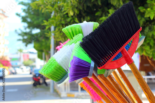 Plastic colorful brooms.