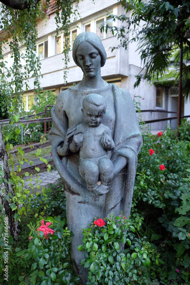 Virgin Mary with baby Jesus statue in the garden of the Blind Center Saint Raphael in Bolzano, Italy Virgin Mary with baby Jesus statue in the garden of the Blind Center Saint Raphael in Bolzano, Italy