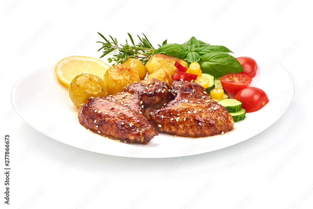 Grilled chicken wings with baked potatoes, Restaurant food, close-up, isolated on white background