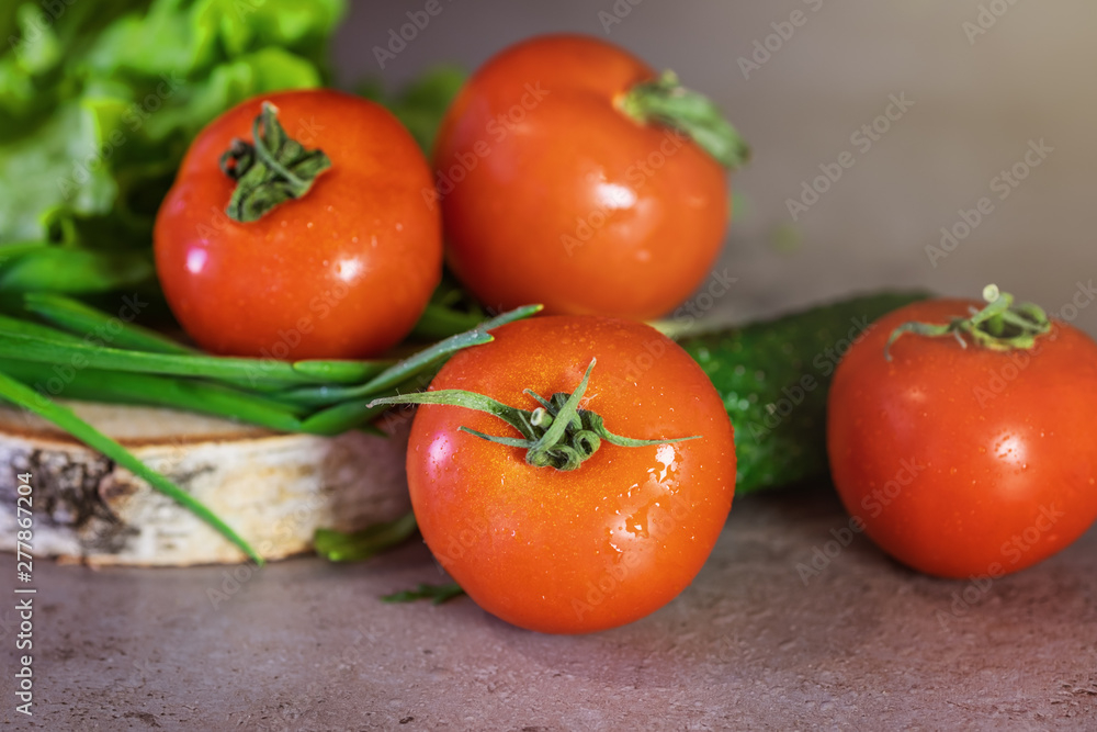 Fresh vegetables and greens for salad , tomatoes, onions, lettuce. The concept of a healthy diet. Fresh vegetables and greens for salad , tomatoes, onions, lettuce. The concept of a healthy diet.