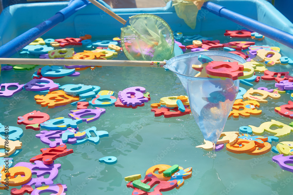 Obraz premium close up of floating colorful marine animal figures in the pool for catching a net. children's entertainment