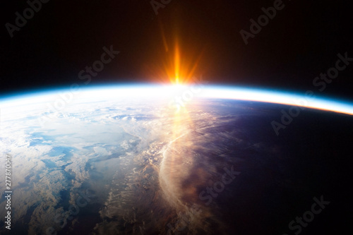 Earth planet and sunrise view from space - element of this image provided by Nasa