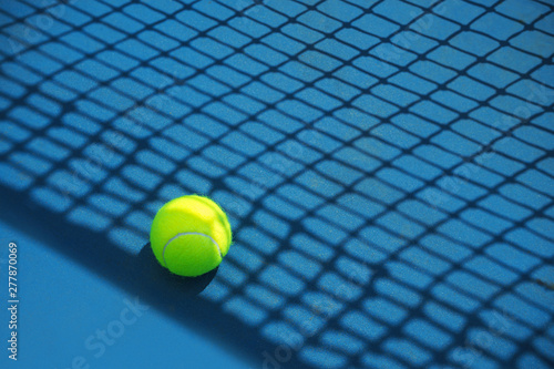 Summer sport concept with tennis ball and net on hard tennis court. Flat lay, top view, copy space. © IrynaV