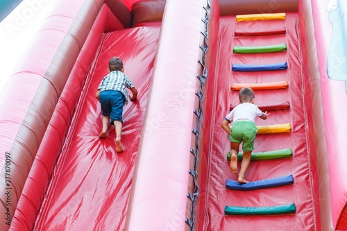 having fun on the slide in the fun park in bouncy castle competing
