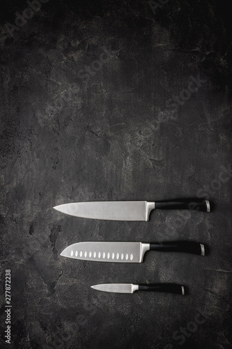 Modern Kitchen Knives Set on Stone Background. Chef's Knives Concept.