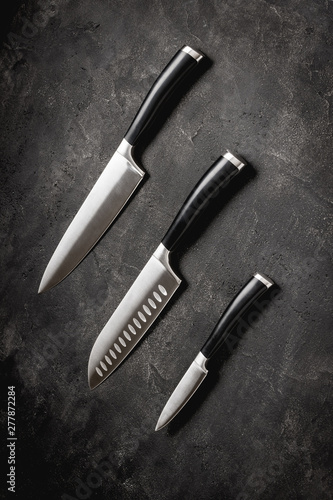 Modern Kitchen Knives Set on Stone Background. Chef's Knives Concept.