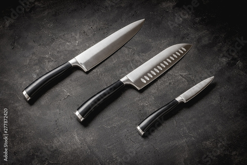 Modern Kitchen Knives Set on Stone Background. Chef's Knives Concept.