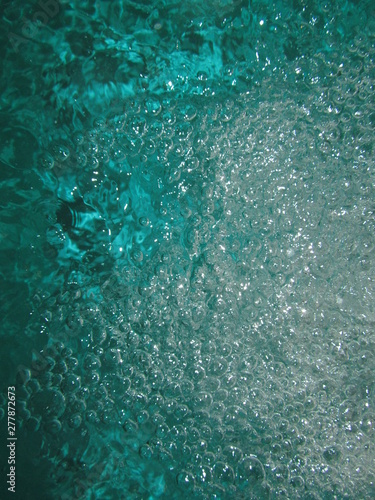 Small air bubbles in the water. Underwater background. Aquamarine bubbles. Water splash. Turquoise bubbles. Aquamarine water. Turquoise water.