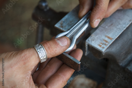 Close-up of a man's hand makes a jaw harps, khomuses, folk musical instruments, selective focus © Sahaidachnyi Roman
