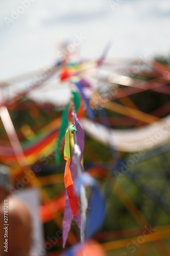 Blurry shot of decorative ornaments of multi-colored ribbons, selective focus.