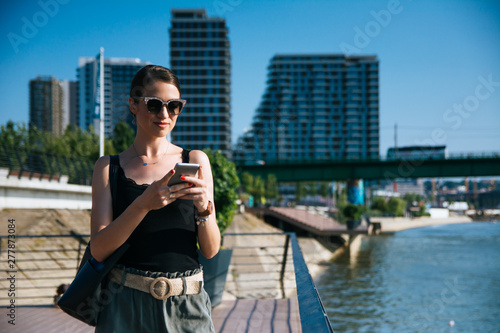 Business woman using her smart Phone © Daniel