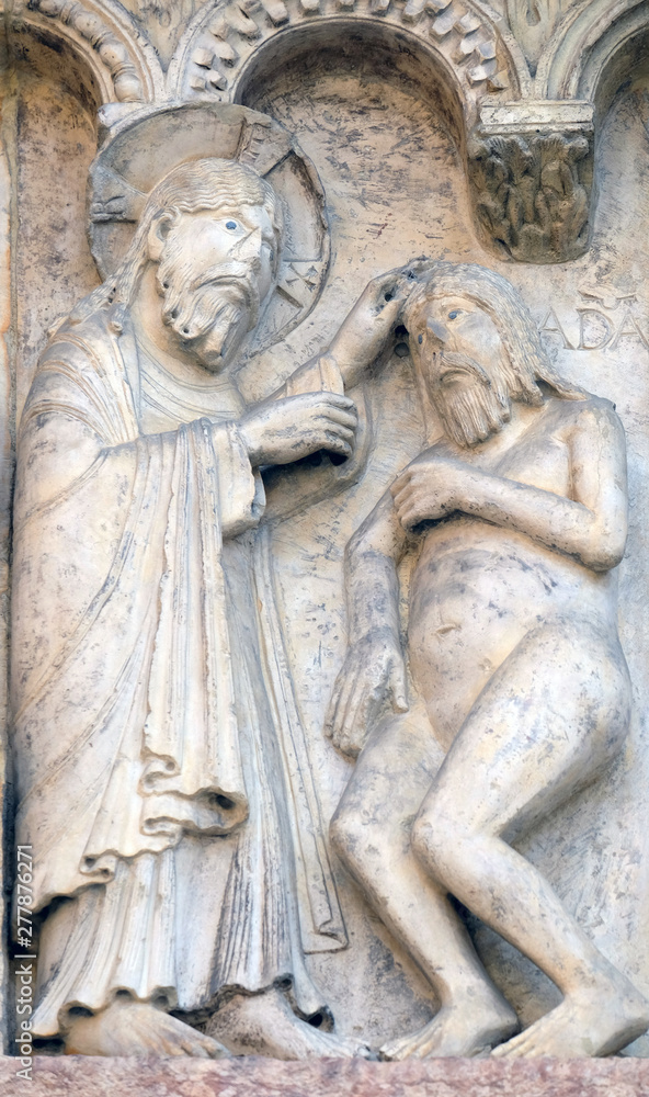 Plate with stories from Genesis: Creation Of Adam relief by Wiligelmo, Modena Cathedral, Italy 