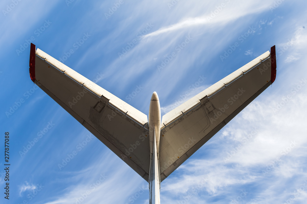 Tail of aircraft. White tail of aircraft on blue sky background. Tail of aircraft. White tail of aircraft on blue sky background.