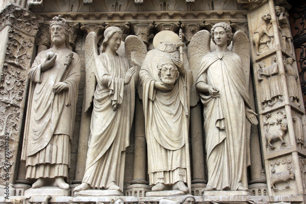 Paris, Notre-Dame cathedral, portal of the Virgin. From left to right: Emperor Constantine, an angel, Saint Denis holding his head, and another angel.