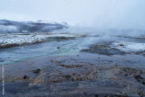 Geothermal lake (hot spring pool) with smoke in Iceland at geysir Strokkur, golden circle