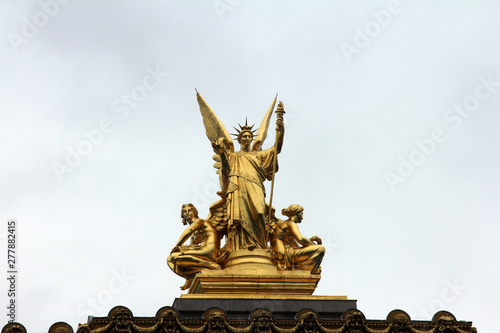 Golden statue of Angel on the top of the Garnier Opera in Paris, France (The Poetry by Charles Gumery)