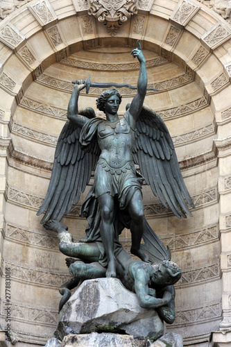 Fountain Saint-Michel at Place Saint-Michel in Paris, France. It was constructed in 1858-1860 during French Second Empire by architect Gabriel Davioud. Archangel Michael and devil by Francisque Duret. photo