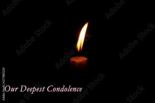 burning candle in the form of heart on black background
