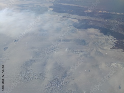 Vanishing coastlines of Greenland as seen from an airplane