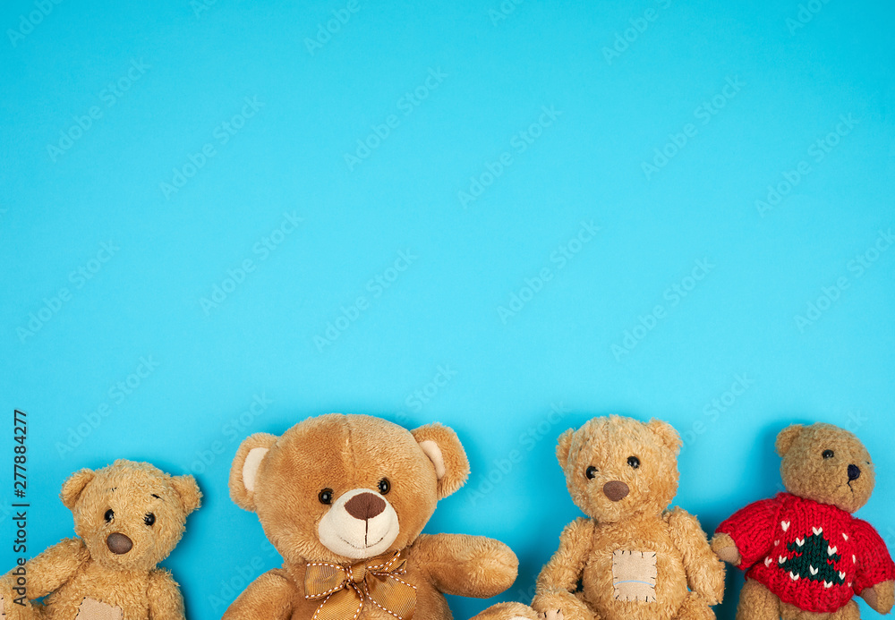 four teddy bears on a blue background, friendship concept