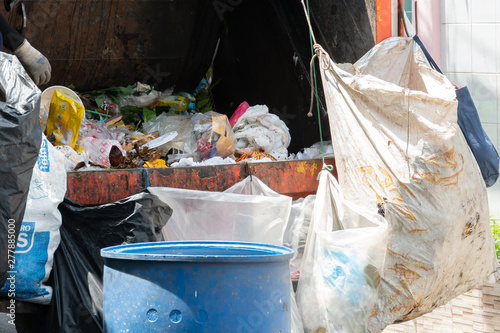 Garbage truck with many trash at the back