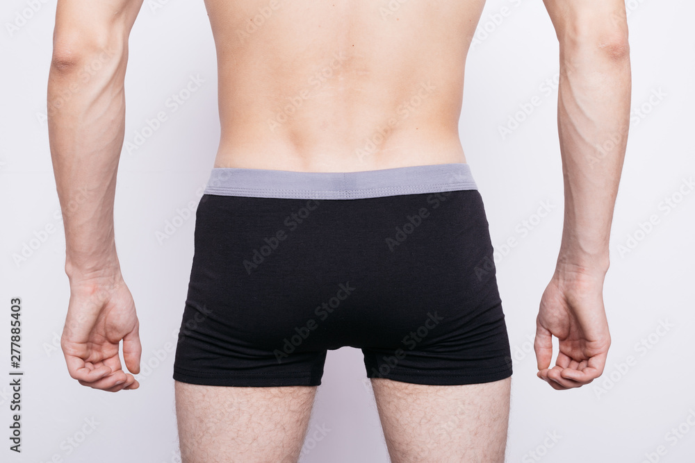 Fotografia do Stock: body parts: men's ass in underwear. inflated buttocks  in boxer shorts. elastic muscles after exercise and diet. concept: diseases  of the anus, constipation and male problems