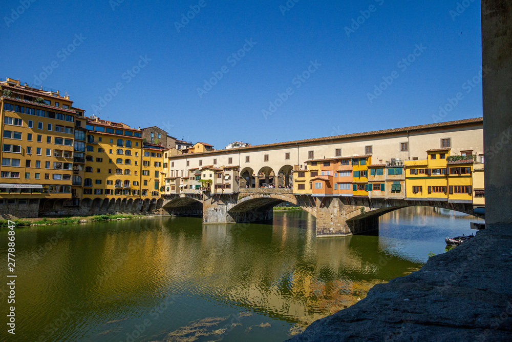 ponte vecchio in florence with reflection in water