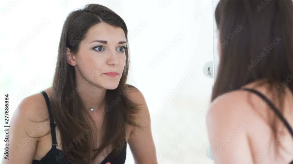 4K. Beautiful sexy woman model in lace lingerie makes up lips. Reflection in mirror, 4K. Beautiful sexy woman model in lace lingerie makes up lips. Reflection in mirror,