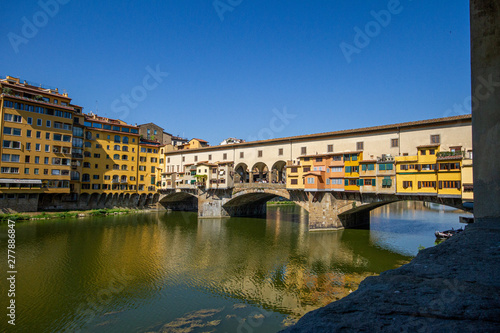 ponte vecchio in florence with reflection in water