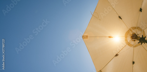 umbrella on blue summer sky