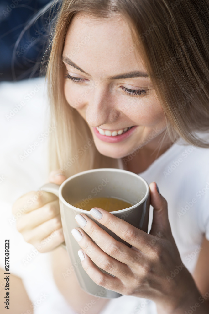 Renew your mind every morning. Close up of cheerful blonde girl drinking coffee in the morning Renew your mind every morning. Close up of cheerful blonde girl drinking coffee in the morning