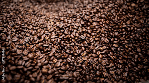 raw coffee beans covered surface close up background and texture detail