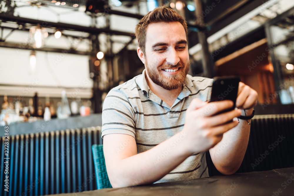Happy smiling customer paying for lunch using new, modern contactless technology with credit card Happy smiling customer paying for lunch using new, modern contactless technology with credit card