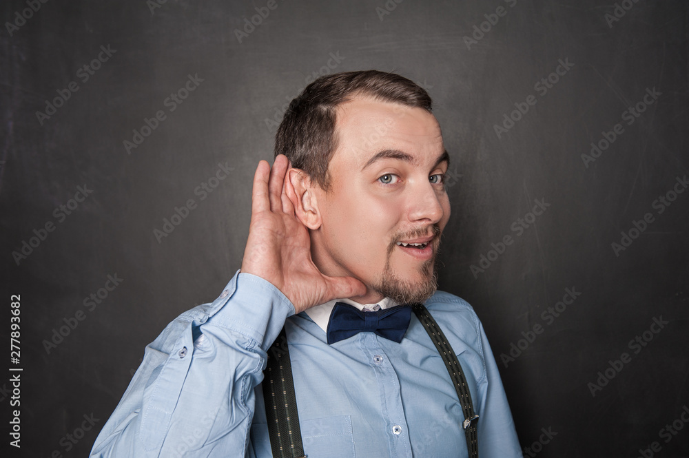 Fototapeta premium Handsome funny man overhear on blackboard