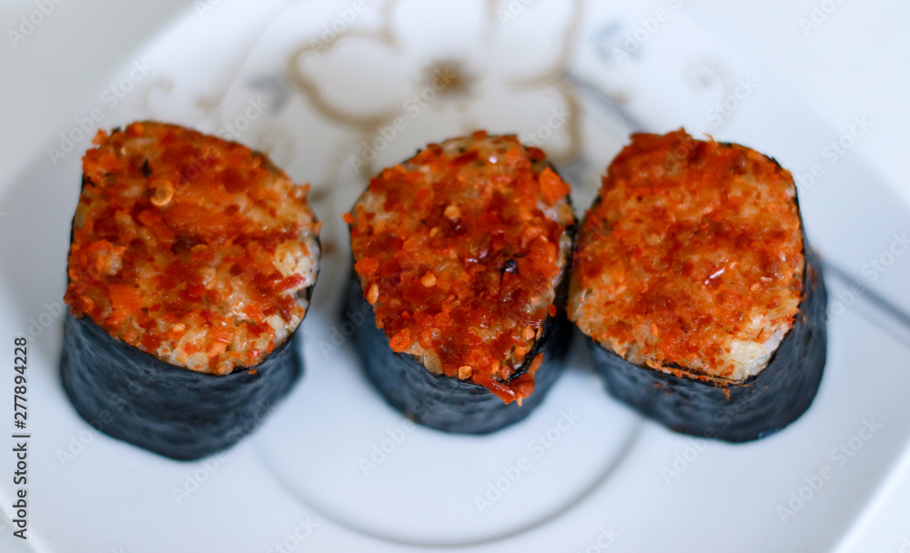 Spicy tuna sushi roll on white background. Spicy tuna sushi roll on white background.