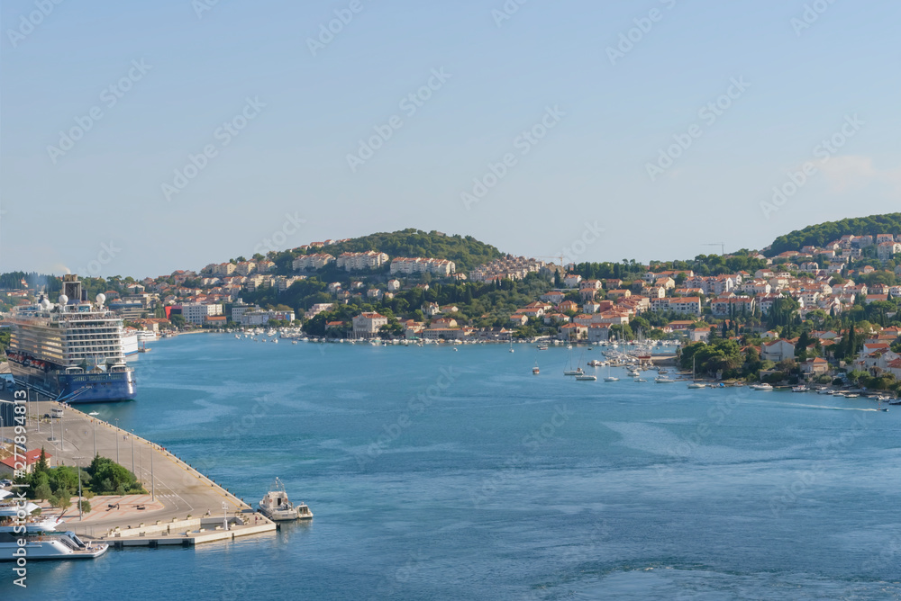 Sea summer landscape of Port of Gruz with ocean cruise ship, skyline, cloudless blue sky Sea summer landscape of Port of Gruz with ocean cruise ship, skyline, cloudless blue sky