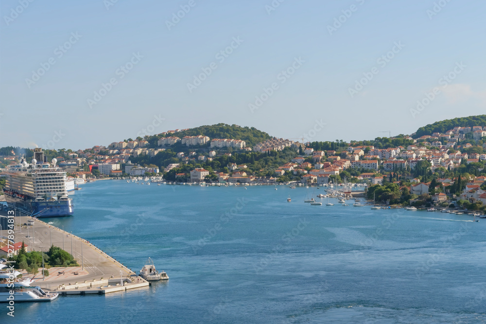 Sea summer landscape of Port of Gruz with ocean cruise ship, skyline, cloudless blue sky