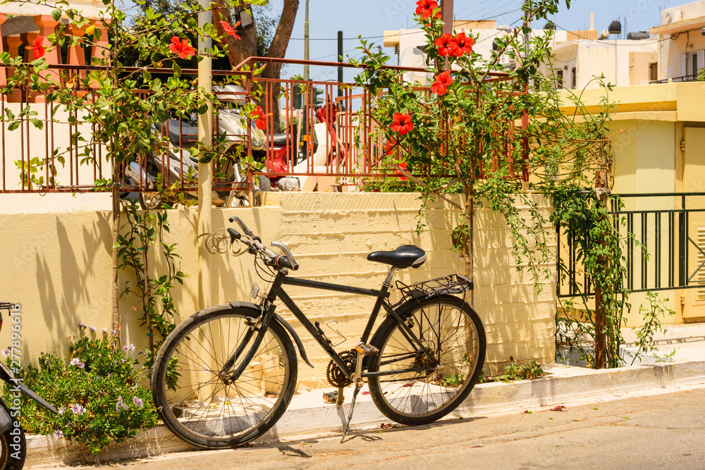 Bicycle is parked close to the wall in Greece