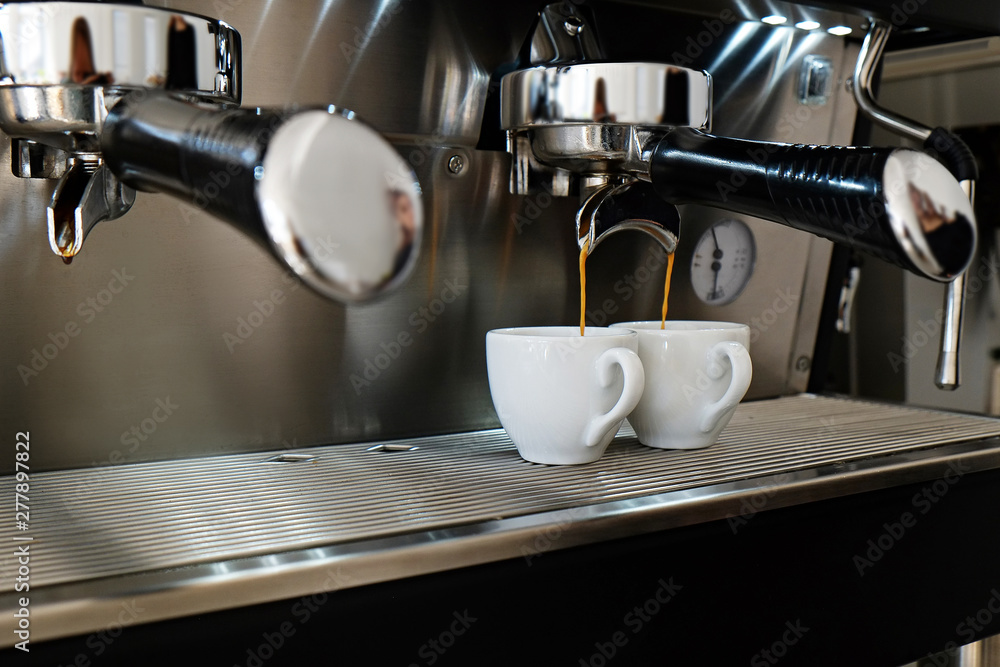 Close up of modern beautiful coffee machine with vintage style black and chrome metal texture design. Macro shot of coffee making equipment. Copy space, background.