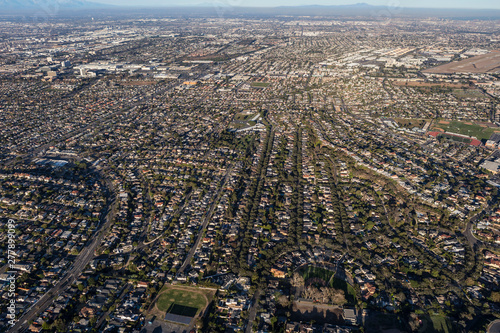 Aerial view of sprawling residential rooftops, streets and buildings in the Southbay area of Los Angeles County, California.