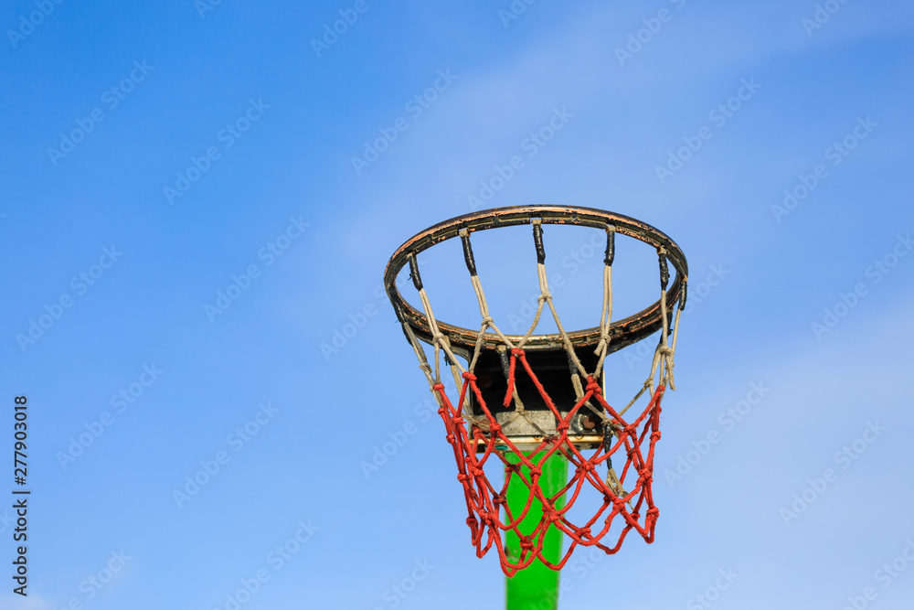 Detail of Basketball hoop in blue sky on a sunny day