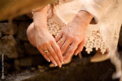 hands of the bride and groom. Hands with rings touching. Couple, marriage, happiness, just married. 