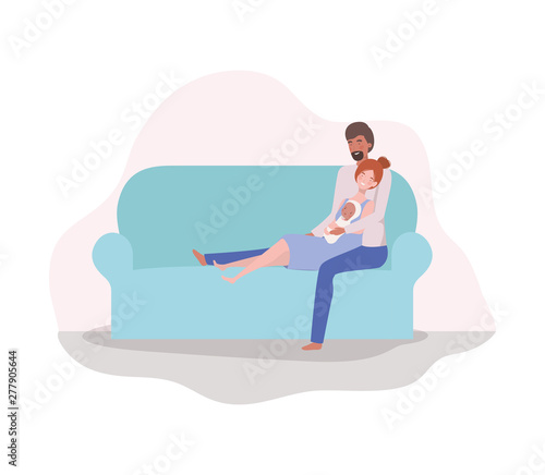 parents taking care of newborn baby in the couch