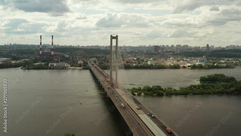 Aerial Shot drone view Flying along the south bridge in Kiev, Ukraine, where a grass car and water around it Aerial Shot drone view Flying along the south bridge in Kiev, Ukraine, where a grass car and water around it
