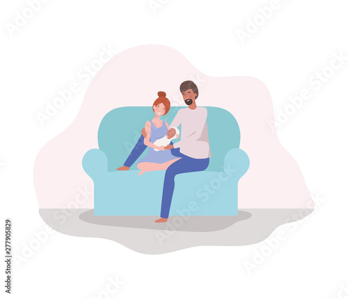 parents taking care of newborn baby in the couch