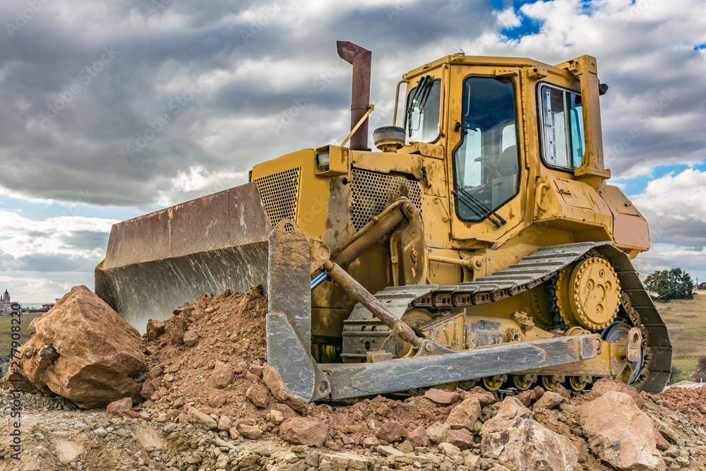 Gravel mountain with an excavator in the background Gravel mountain with an excavator in the background